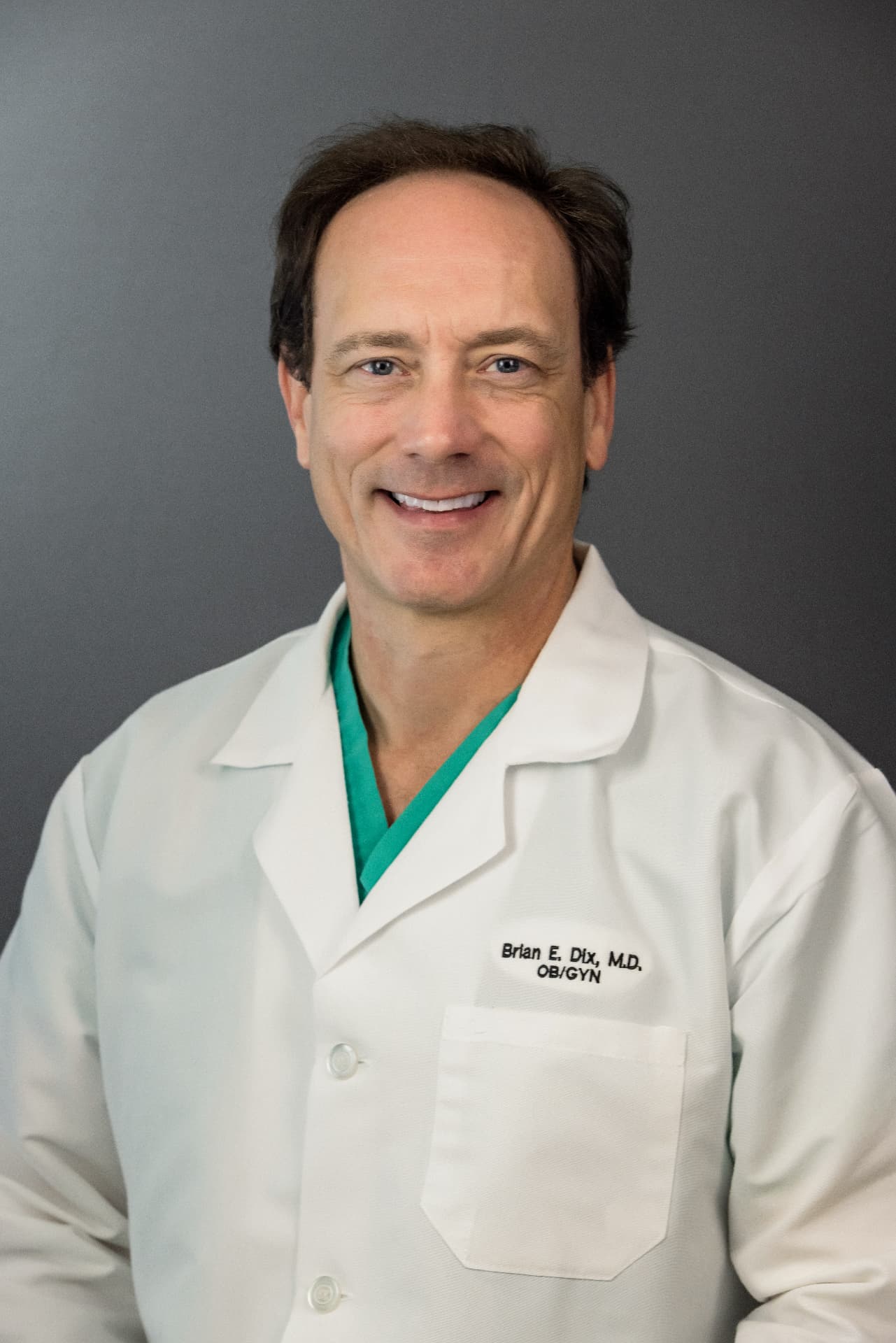 Physician headshot in a white coat