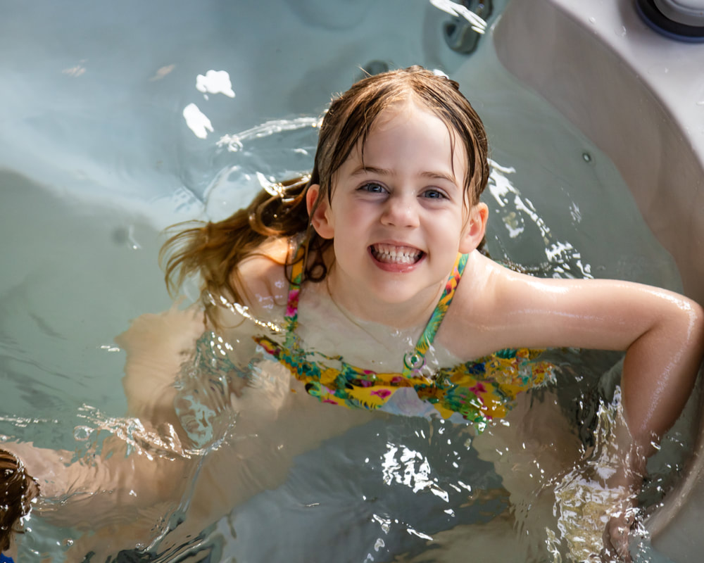 Girl smiling in the water on her birthday