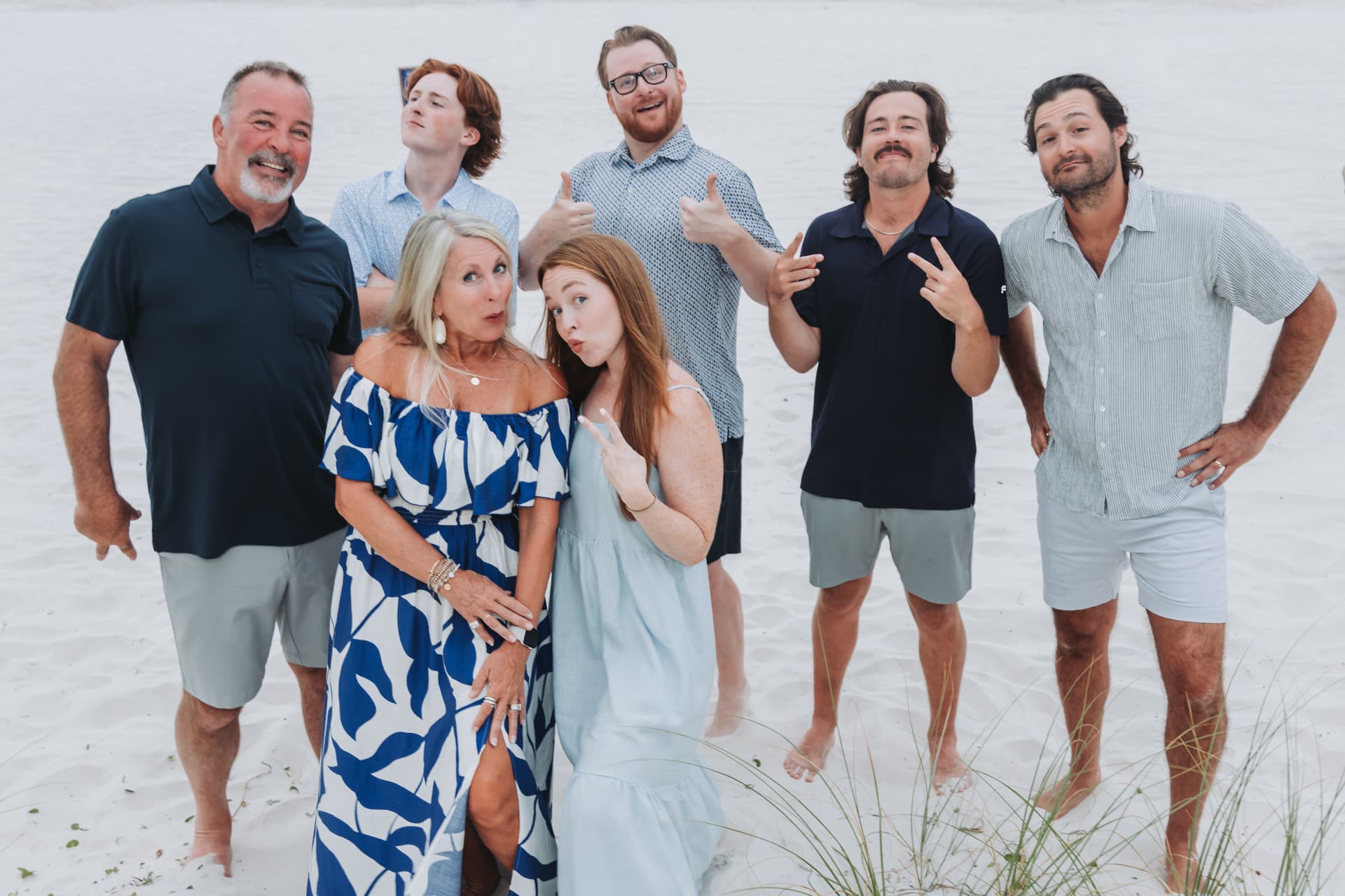 Family making silly faces on the beach