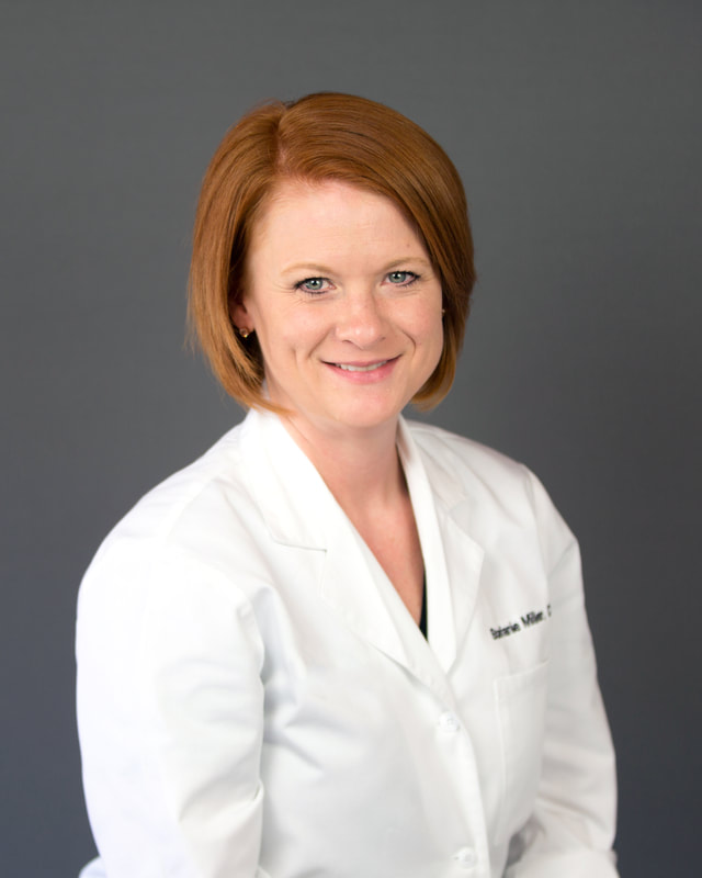 Medical professional headshot on gray backdrop