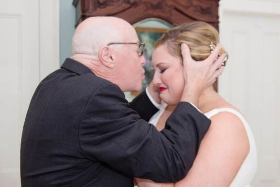 Father kissing the bride on the forehead before the ceremony