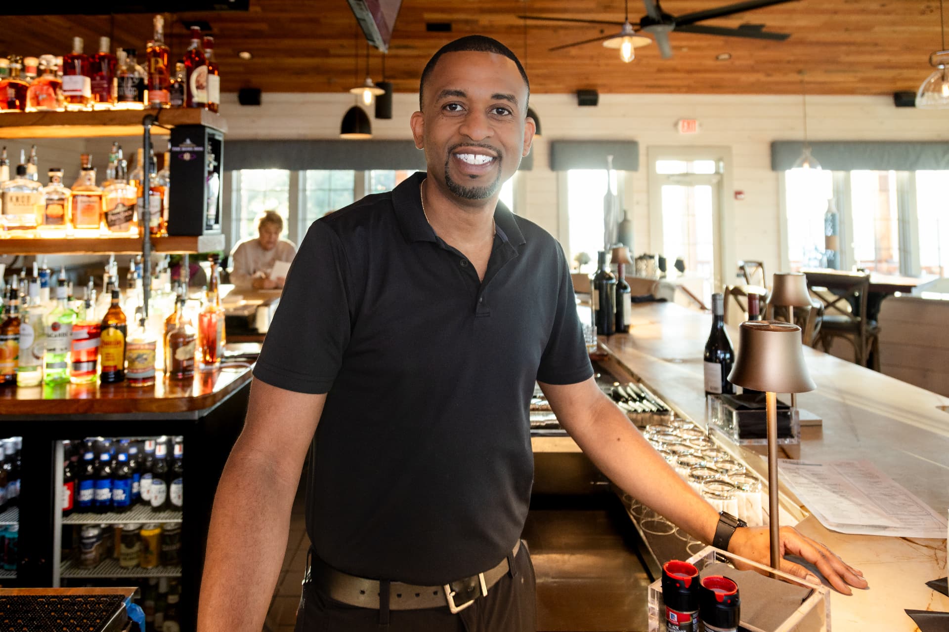 Restaurant manager photographed behind the bar