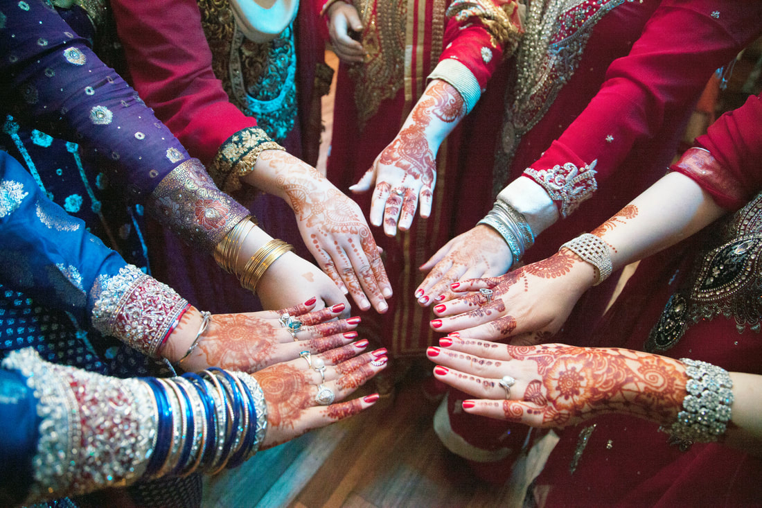 Henna hands gathered in a circle before the ceremony