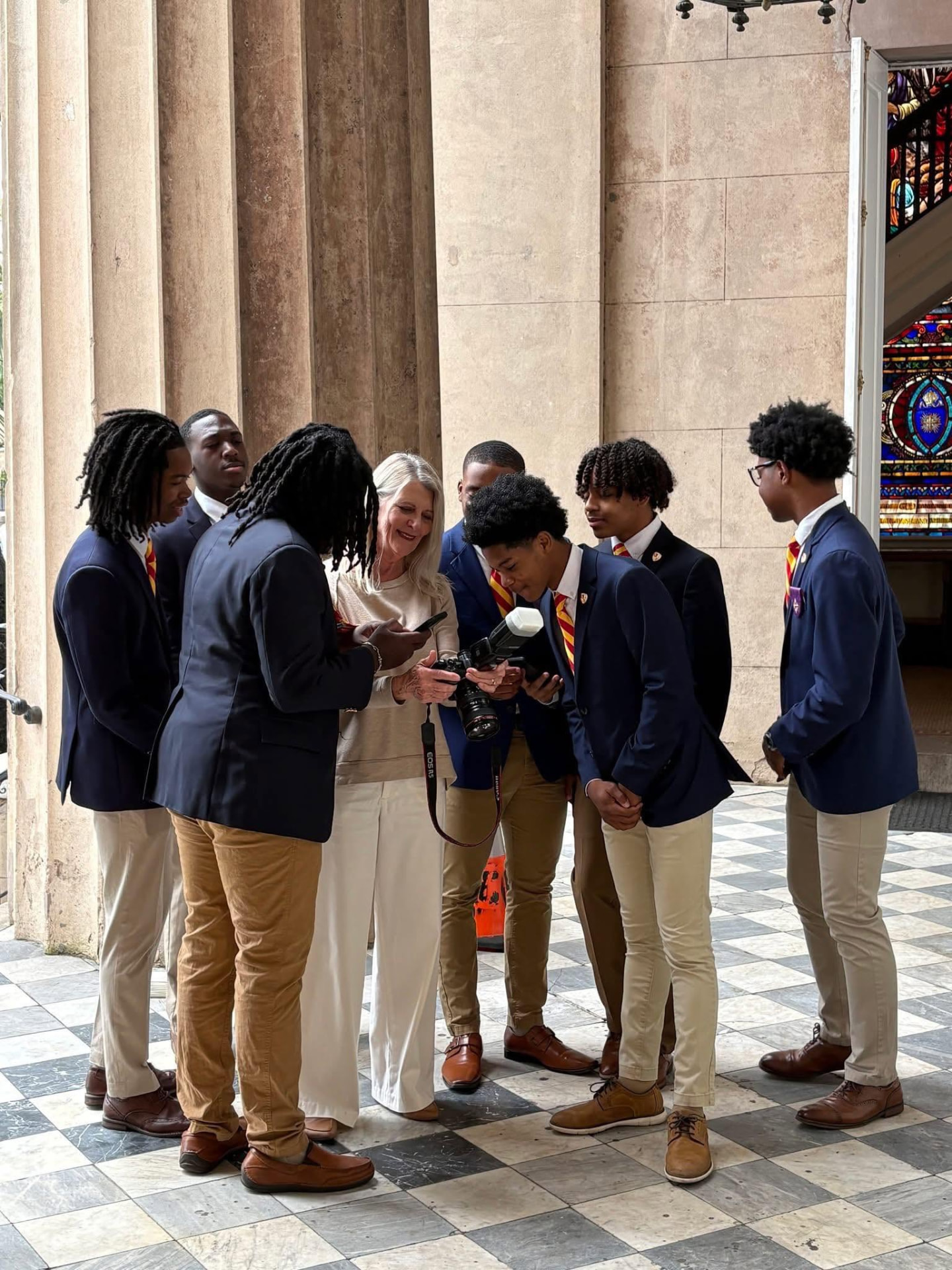 Cindy showing her camera to a group of Kappa League students