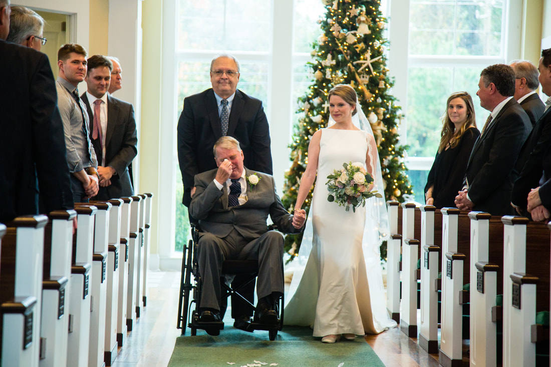 Bride walking down the aisle with her family