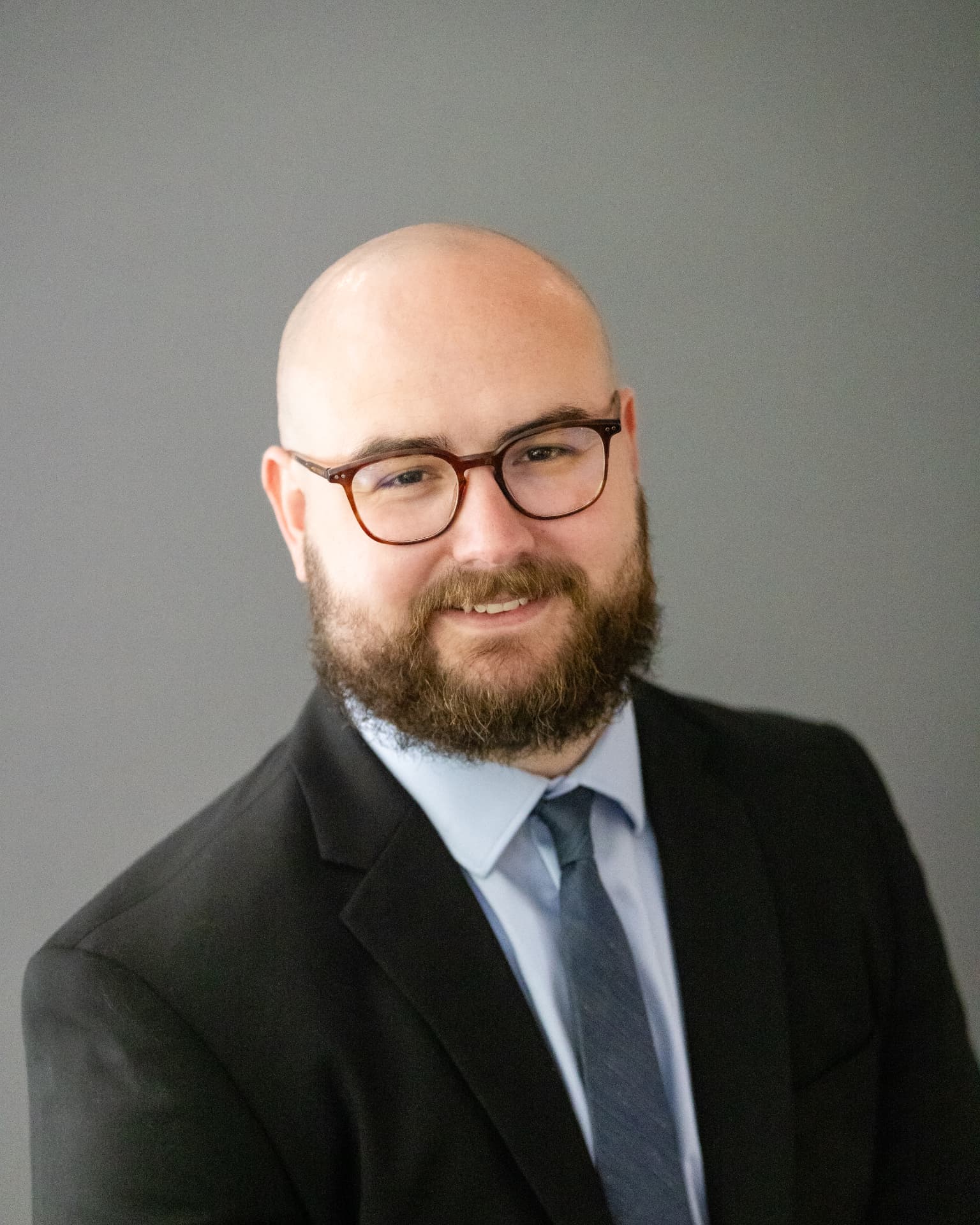 Business headshot on a light grey backdrop
