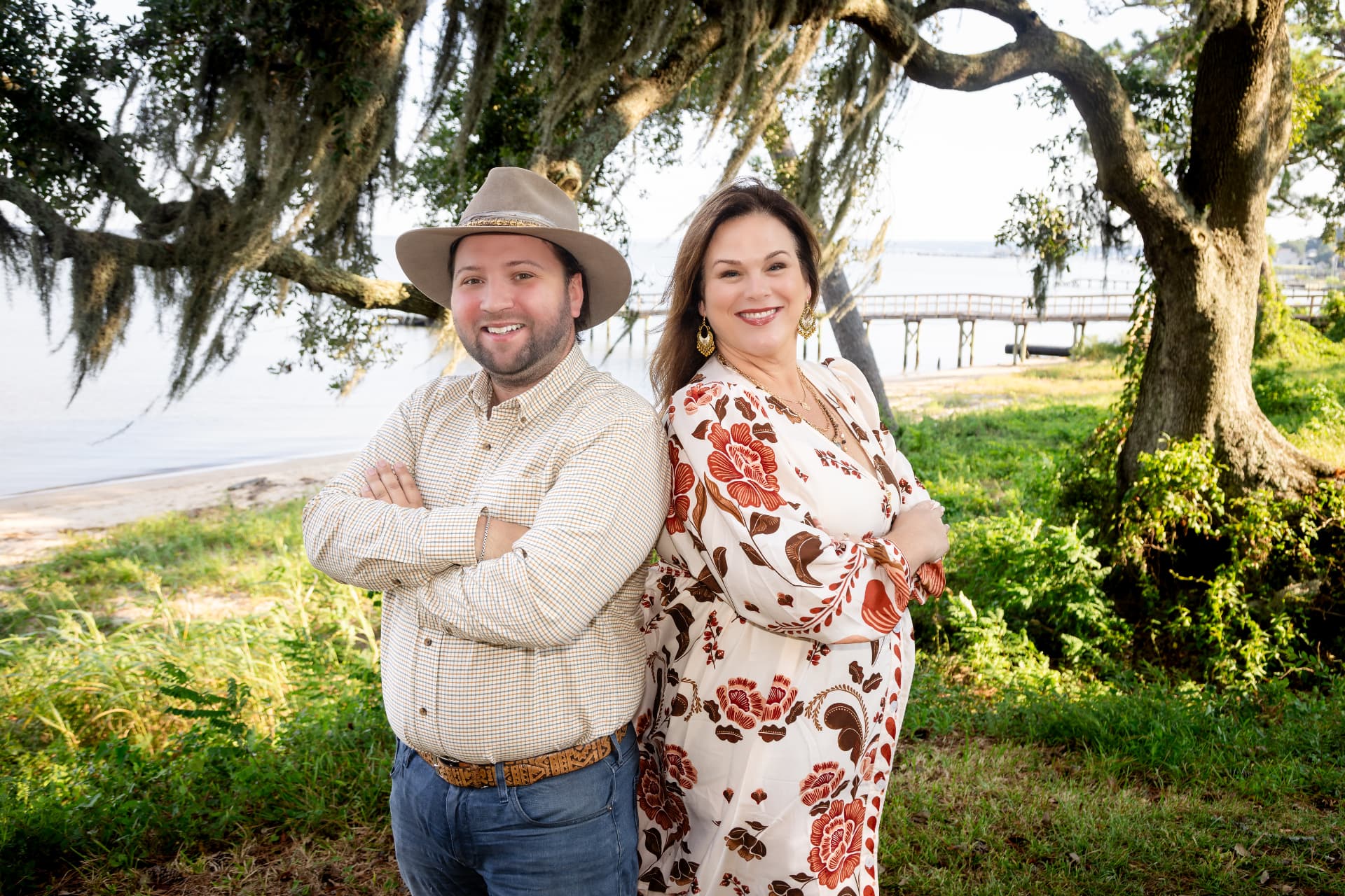 Couple photographed under live oaks by the bay