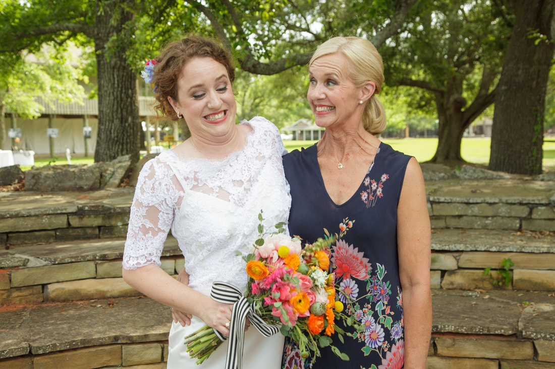 Bride laughing with her mother before the ceremony