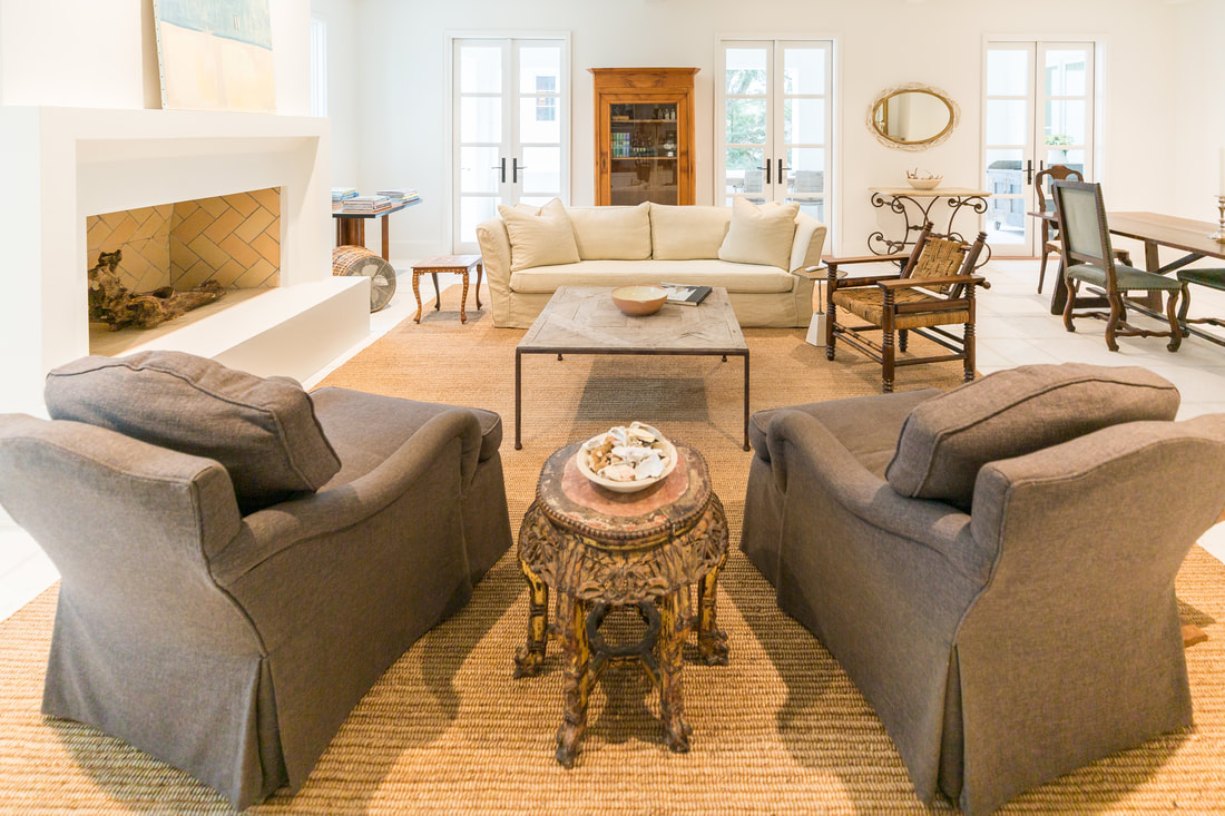 Living room with linen sofa, fireplace and antique side table