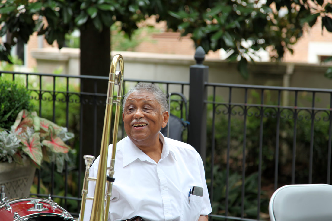 Musician photographed outdoors with his trombone