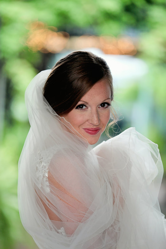 Bride looking over her shoulder through her veil