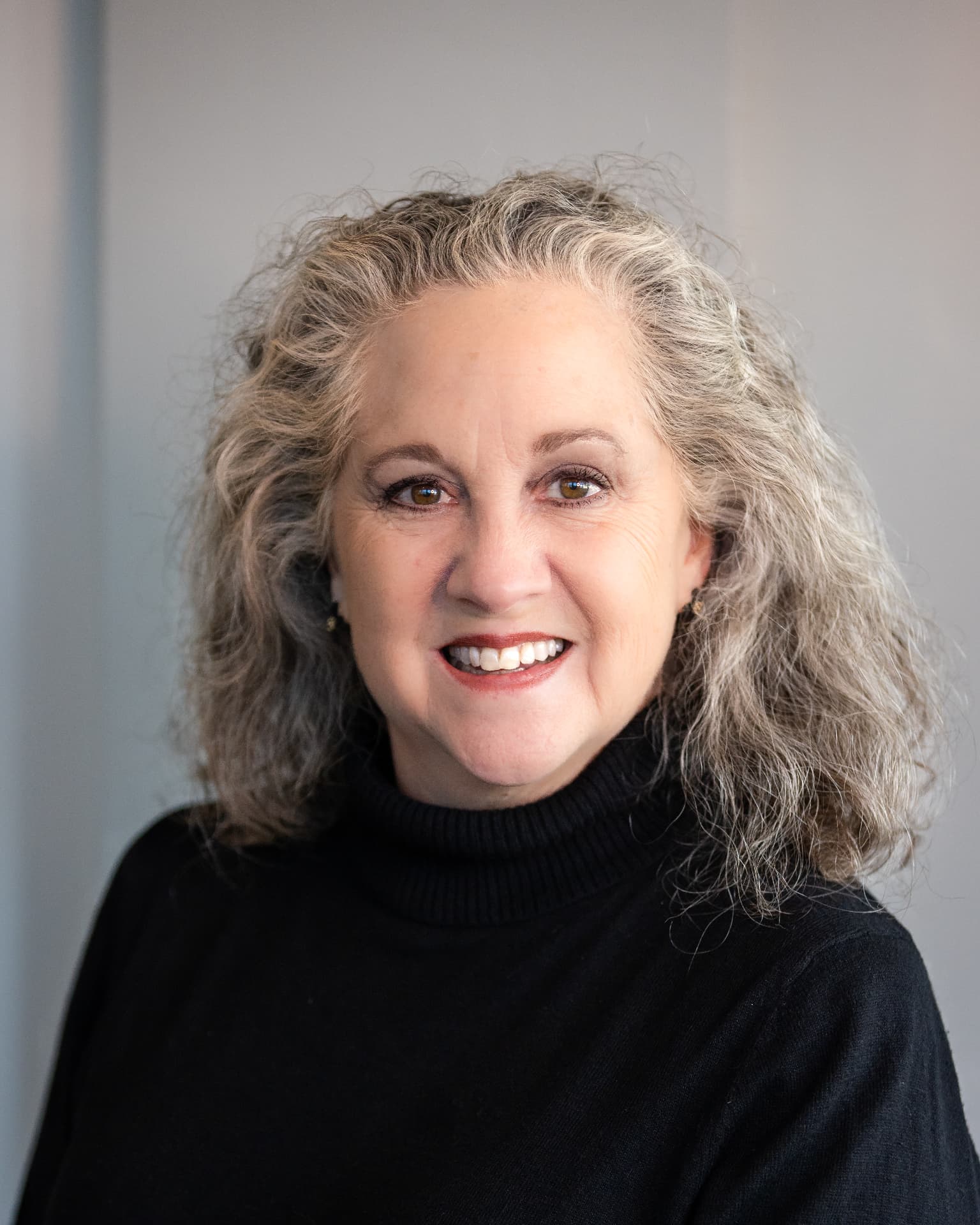 Chamber of commerce member headshot in a black turtleneck