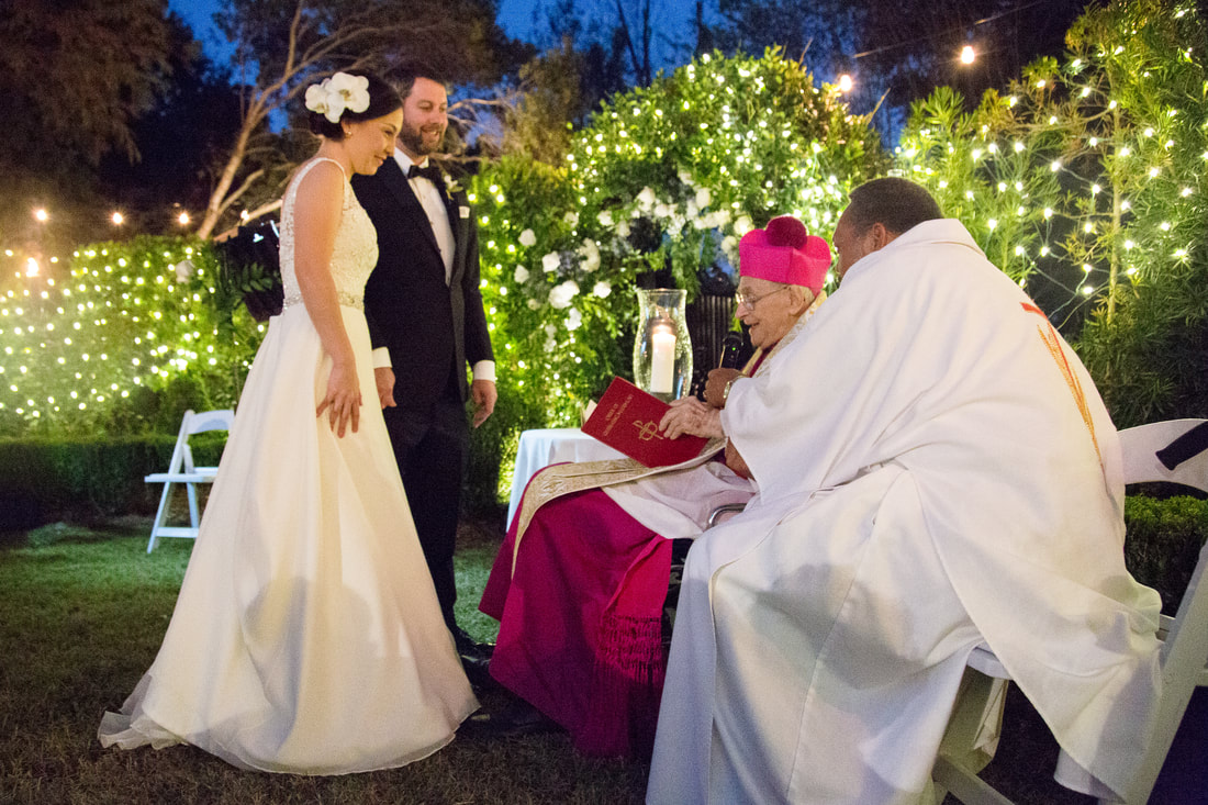 Couple receiving a blessing at the garden altar