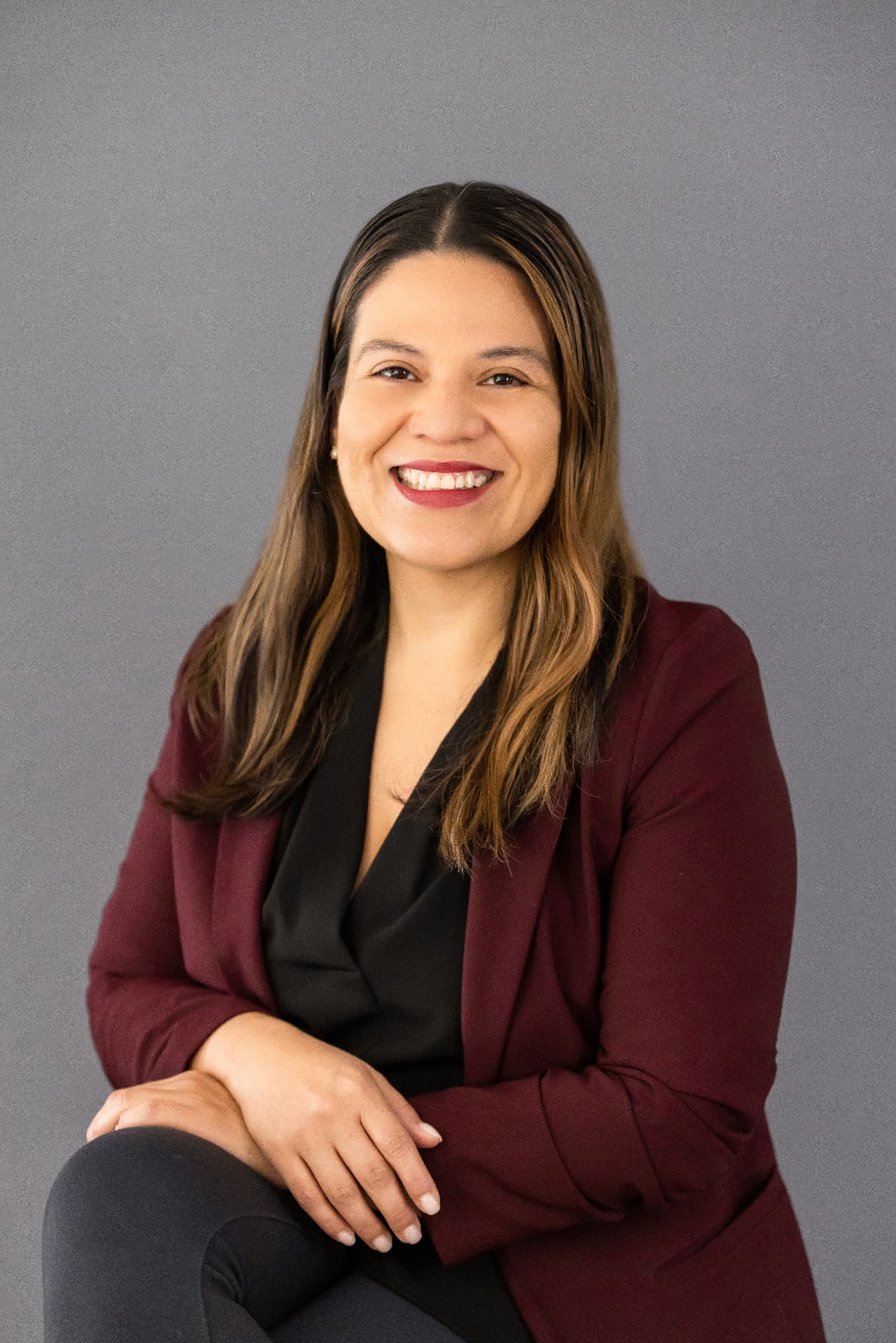 Professional headshot on a grey studio backdrop