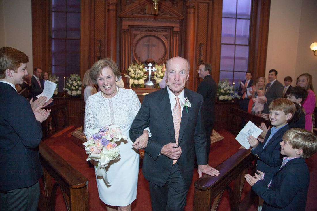 Couple walking back up the aisle to applause