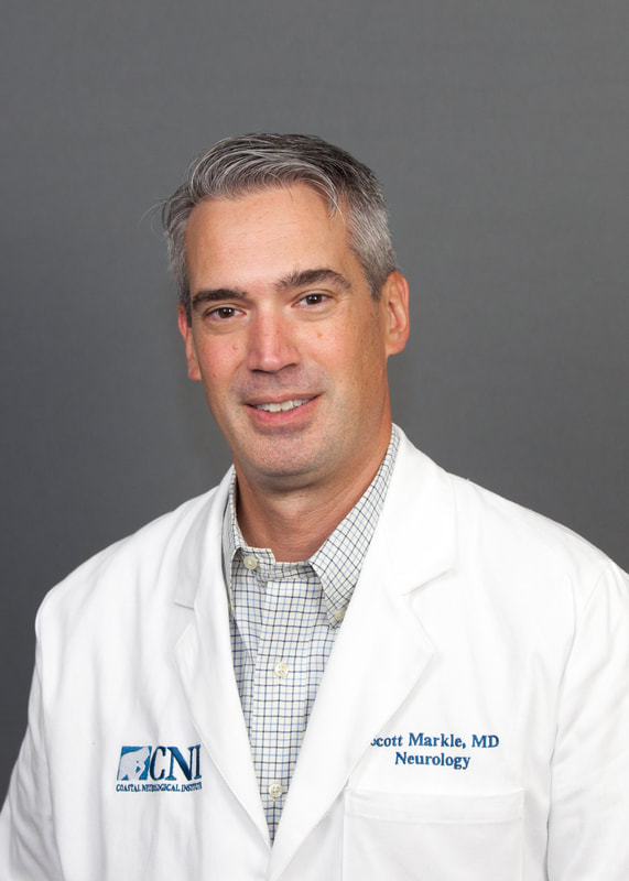 Neurologist headshot on gray backdrop