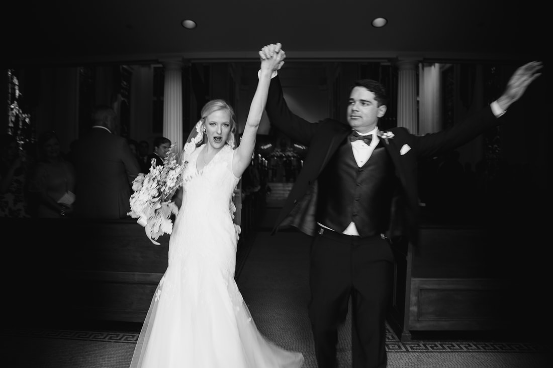 Black and white recessional with hands raised in celebration
