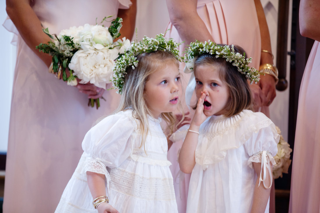 Flower girls whispering during the ceremony