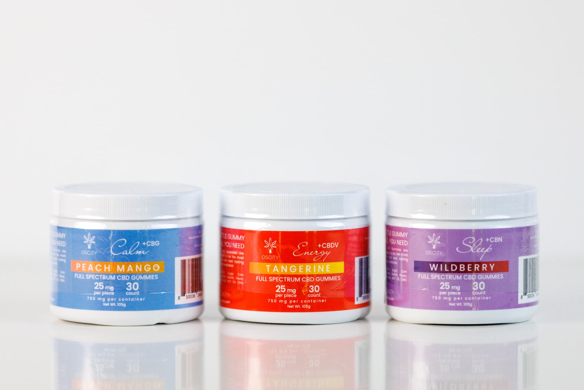 Three OScity full spectrum CBD gummy jars in peach mango, tangerine, and wildberry