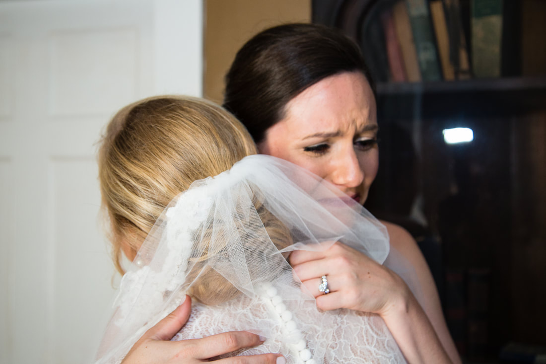 Bride embracing a friend in an emotional moment before the ceremony