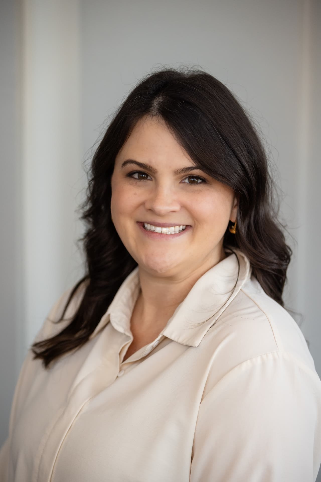Professional headshot in a cream blouse