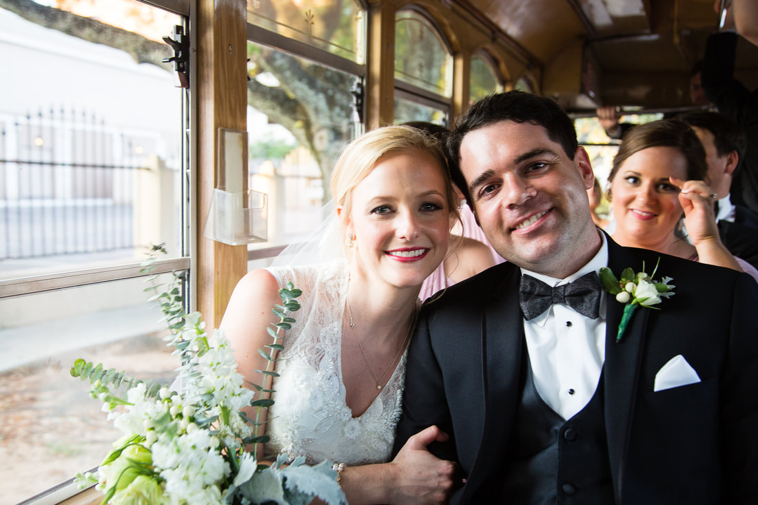 Bride and groom riding a trolley after the ceremony