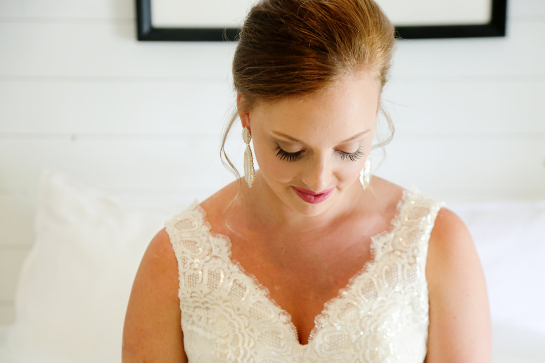 Close portrait of the bride looking down before the ceremony