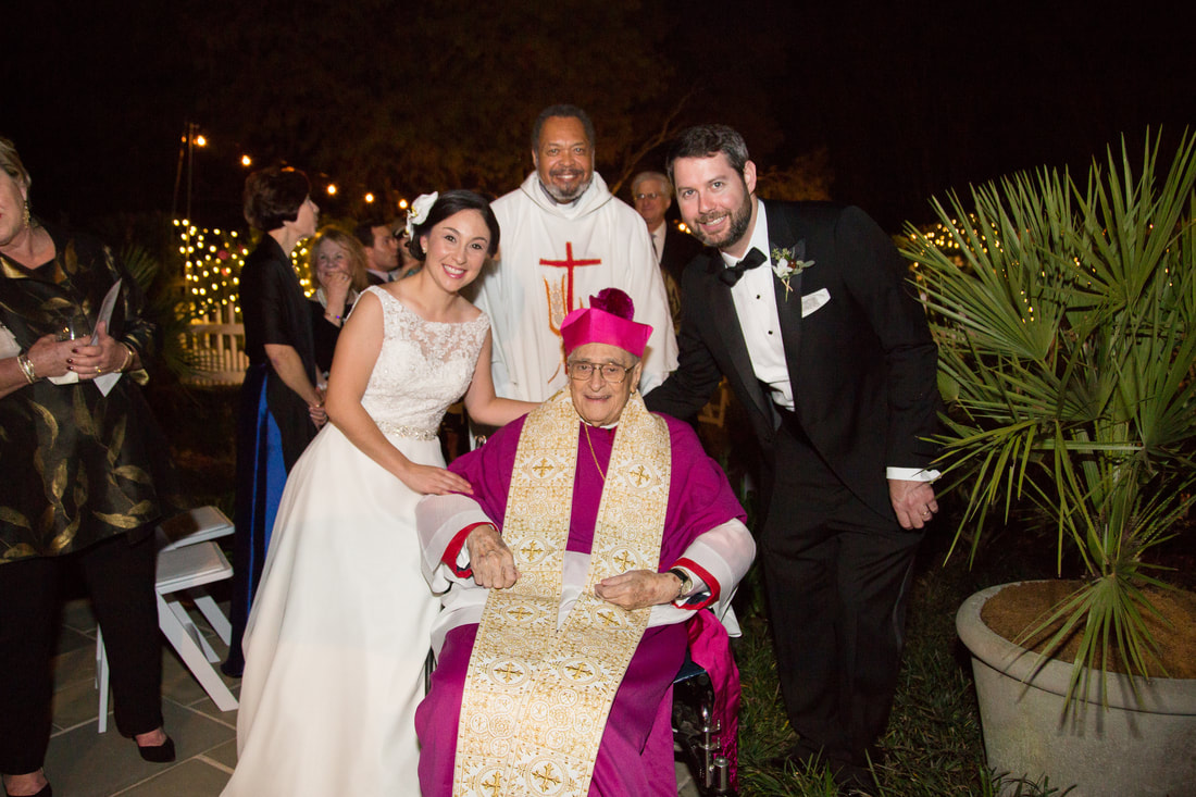 Newlyweds with the clergy after the ceremony