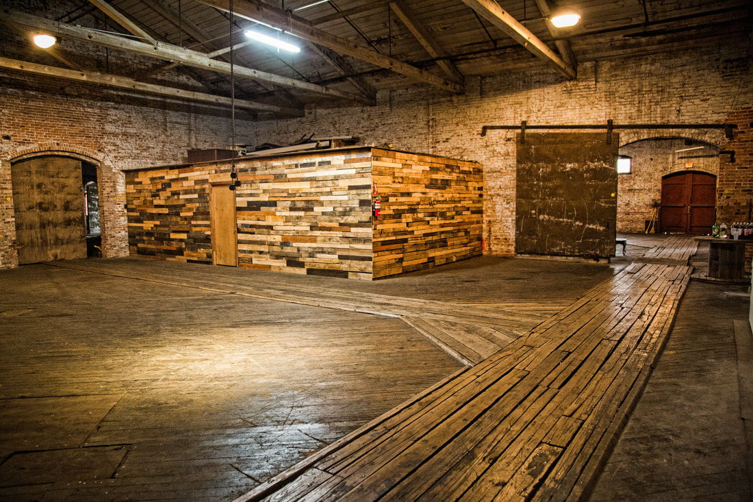 Restored brick warehouse event space with reclaimed wood bar